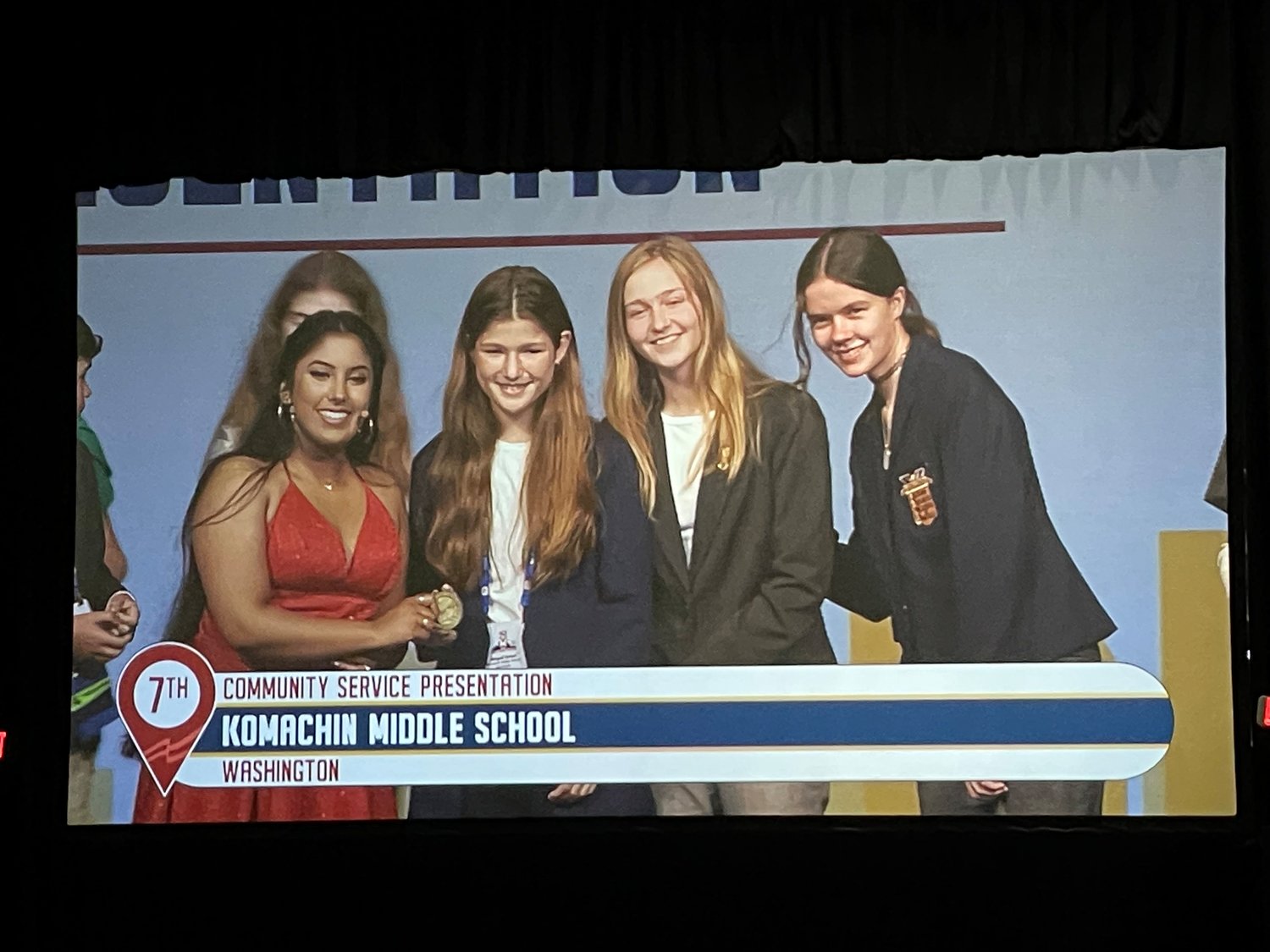 Community Service Presentation team members Alyssa Childers, Abigail Green and Natalie Terekhina, shown on the projection screen at  the McCormick Place Convention Center in Chicago at the FBLA conference.
